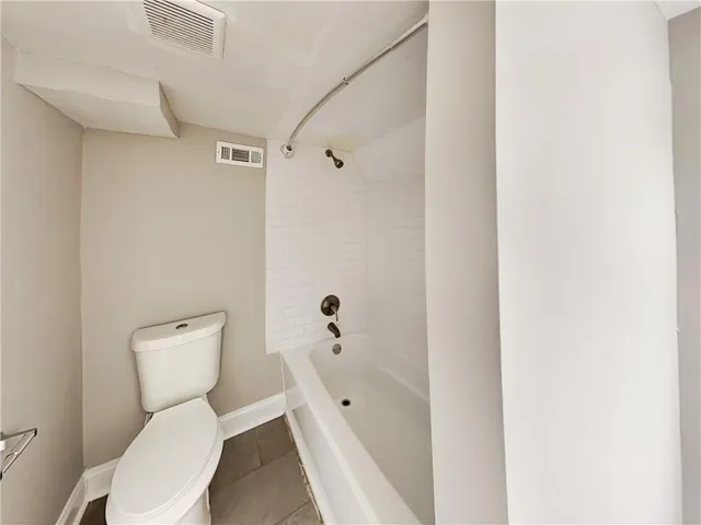 a white toilet sitting next to a bathroom sink