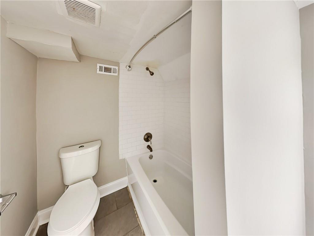 2875 3rd Avenue Southwest, Unit B Atlanta, GA 30315 - Photo 16 of 20 a white toilet sitting next to a bathroom sink