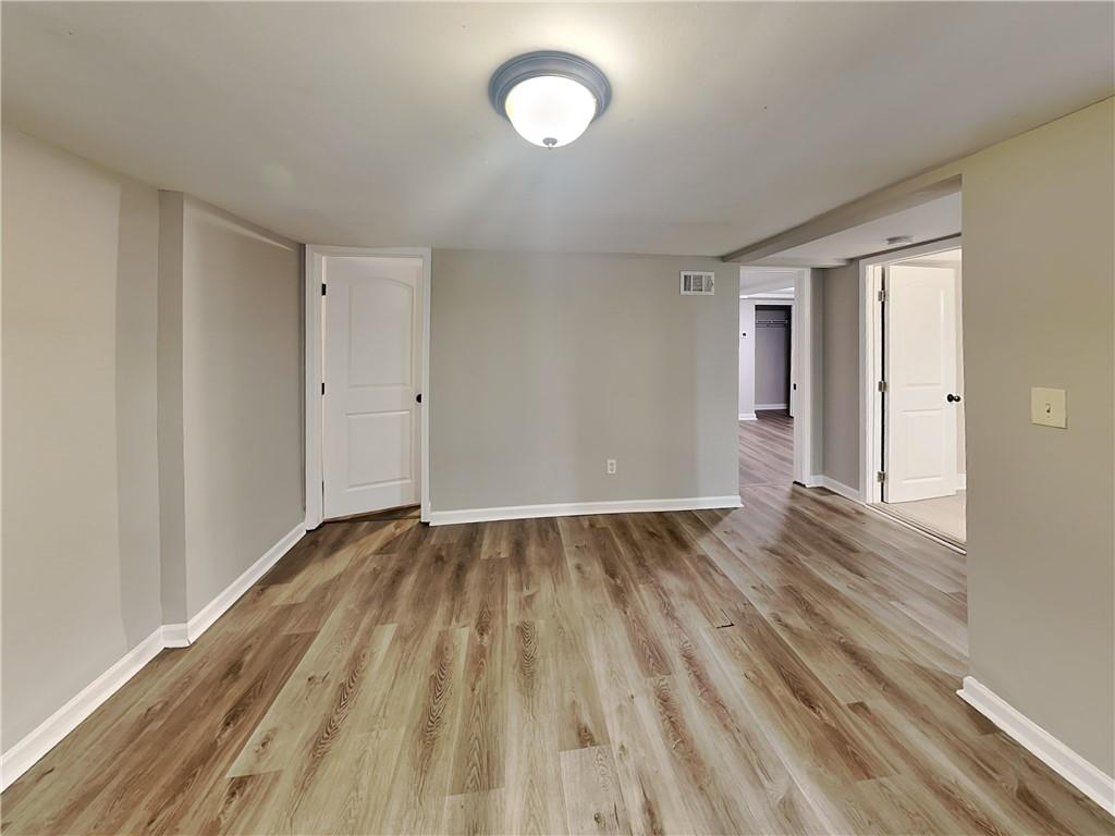 2875 3rd Avenue Southwest, Unit B Atlanta, GA 30315 - Photo 6 of 20 wooden floor in an empty room with a window
