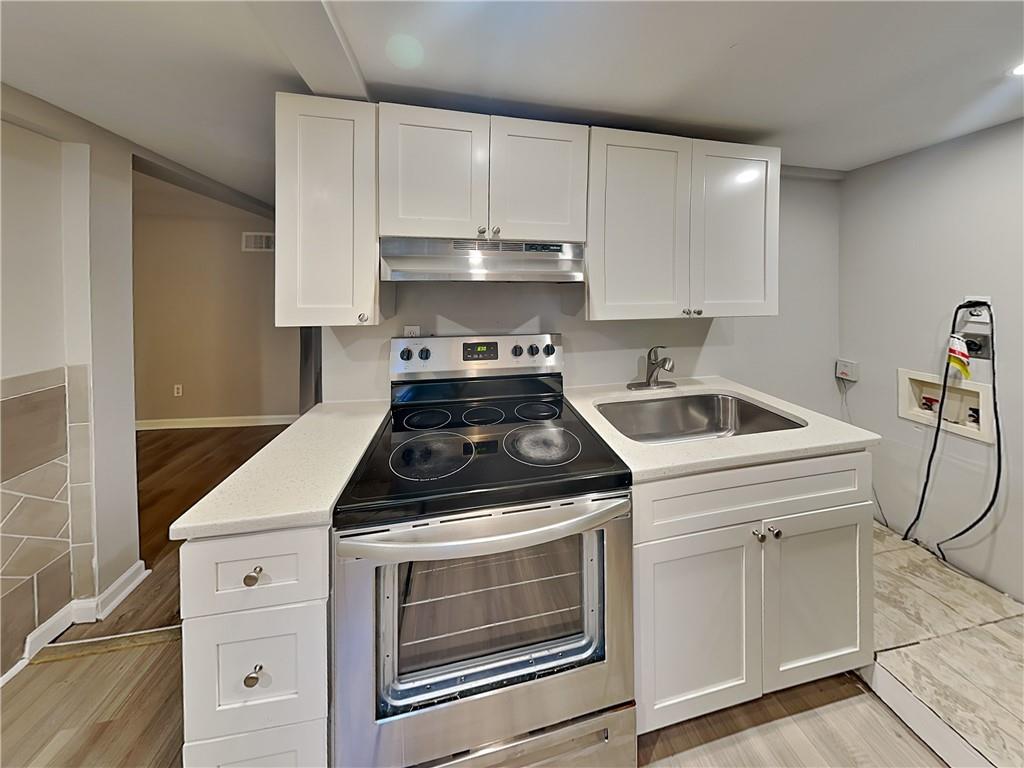 2875 3rd Avenue Southwest, Unit B Atlanta, GA 30315 - Photo 9 of 20 a kitchen with white cabinets and white appliances