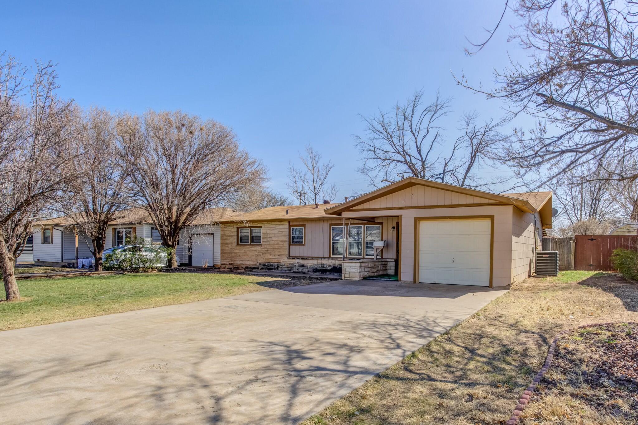 3013 45th Street Lubbock, TX 79413 - Photo 2 of 30 a front view of a house with a yard covered in snow