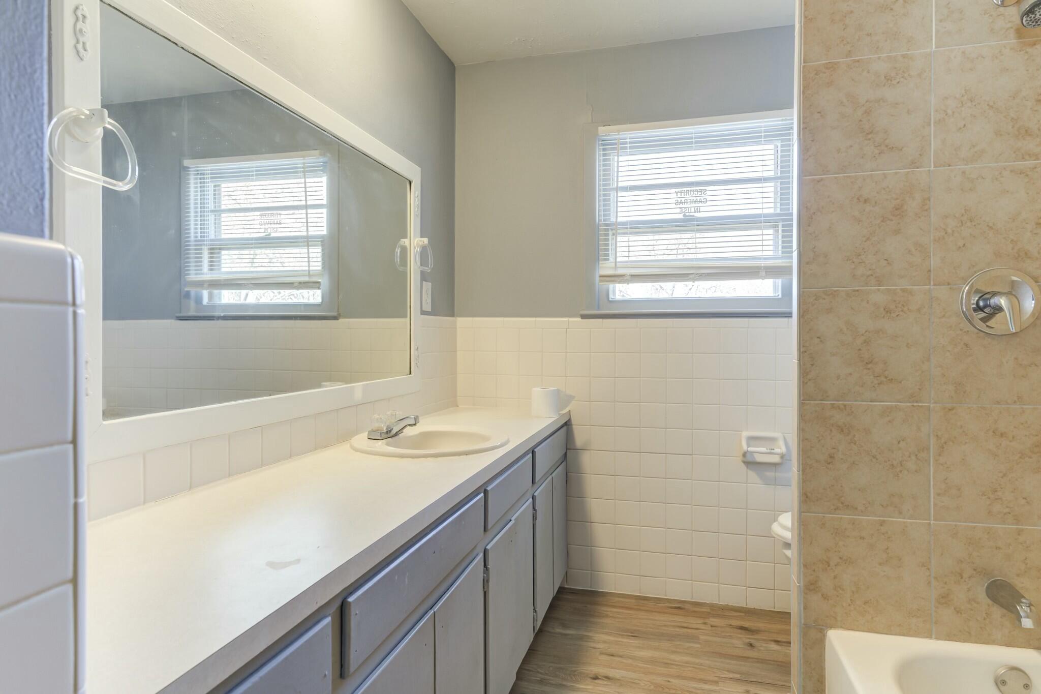 3013 45th Street Lubbock, TX 79413 - Photo 22 of 30 a bathroom with a sink and a bathtub