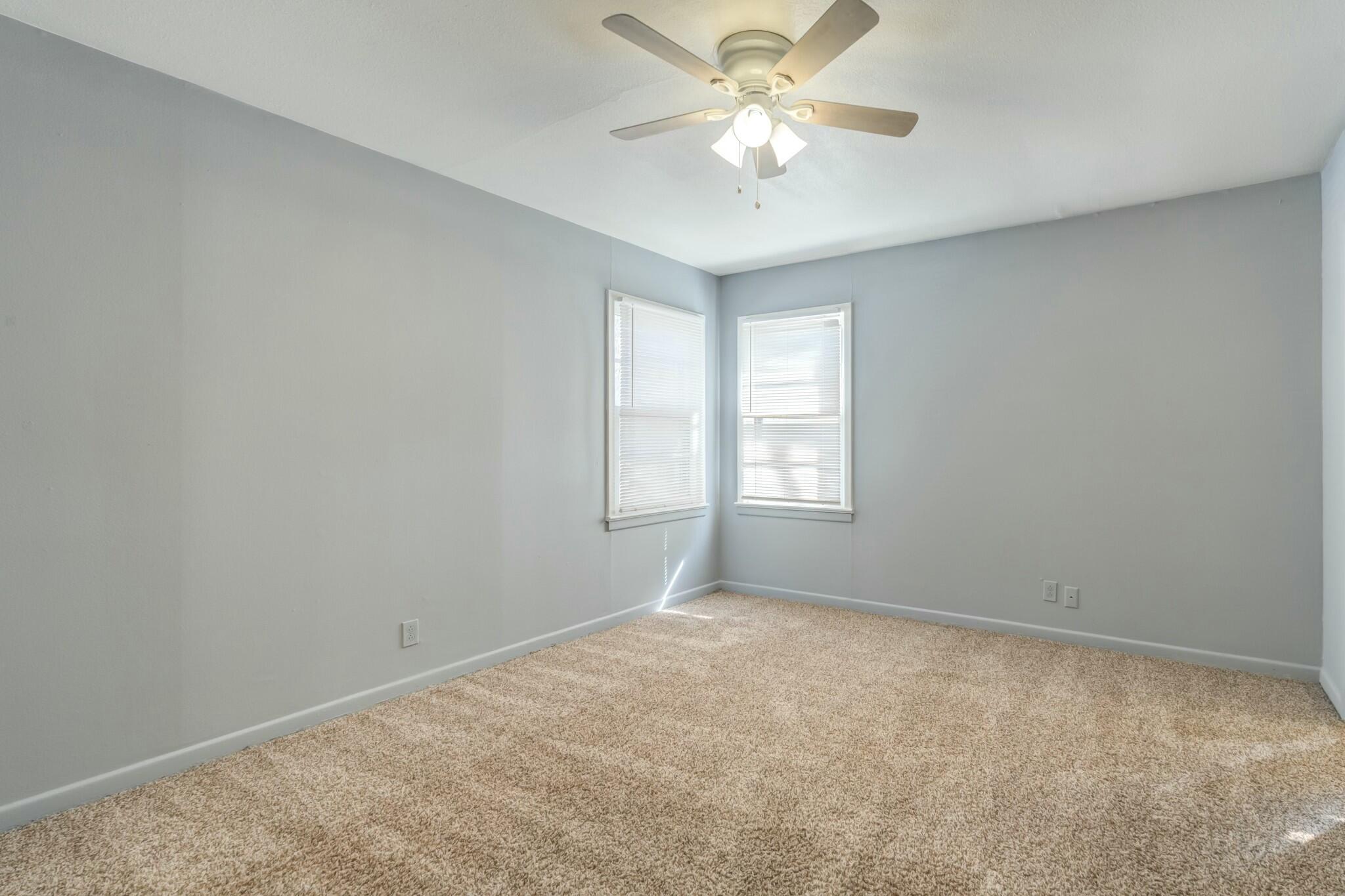 3013 45th Street Lubbock, TX 79413 - Photo 25 of 30 an empty room with a window and a fan