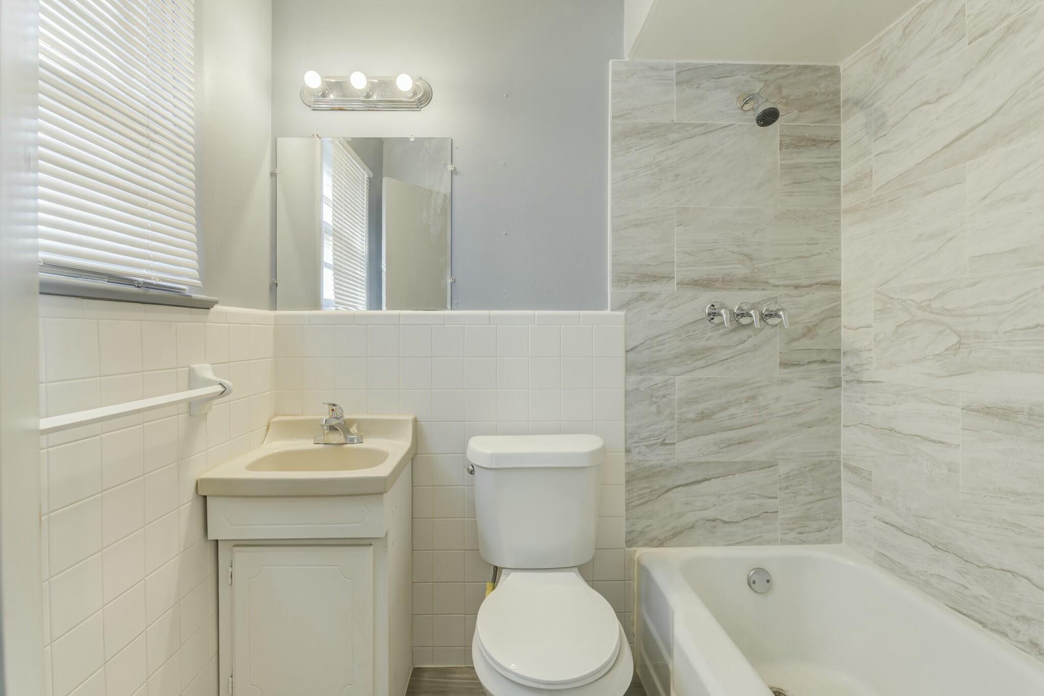 3013 45th Street Lubbock, TX 79413 - Photo 27 of 30 a bathroom with a sink a toilet and shower