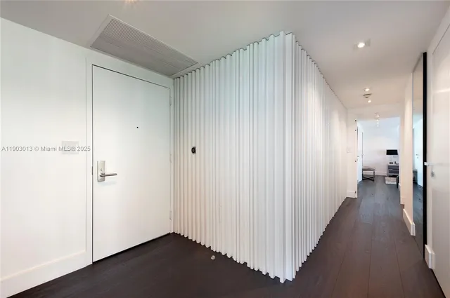 a view of a hallway with a dining area