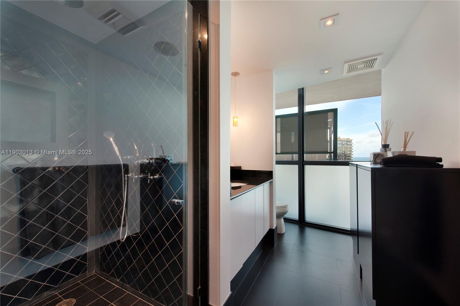 101 20th Street, Unit 1907 Miami Beach, FL 33139 - Photo 12 of 14 a kitchen with a refrigerator and a stove