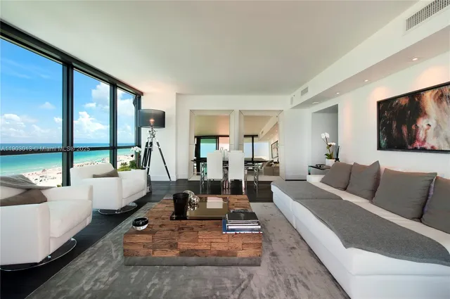 a living room with furniture large window and a flat screen tv