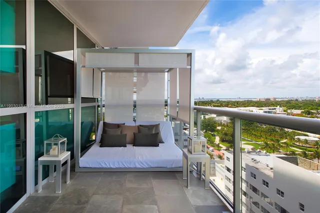 a bedroom with furniture and large window