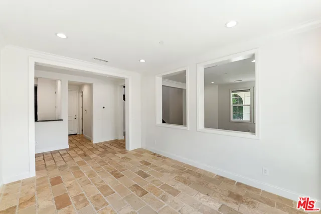a view of a hallway with wooden floor and stairs