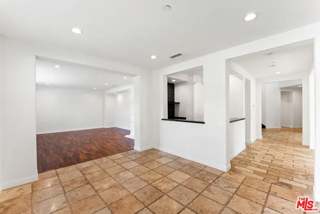 a view of an empty room with a fireplace and a window