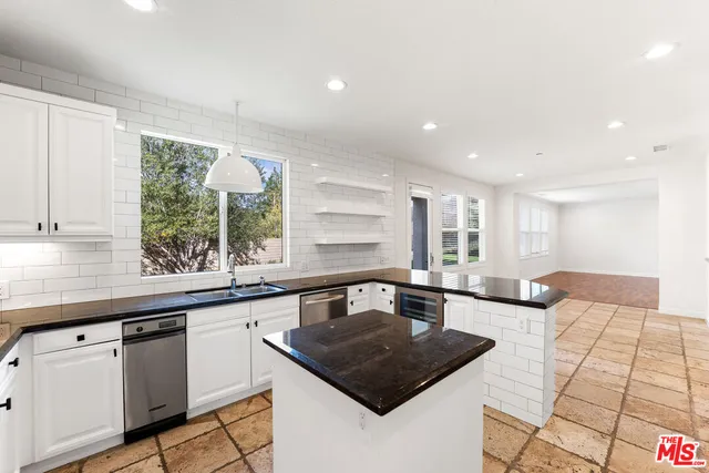 a bathroom with a sink vanity mirror and toilet