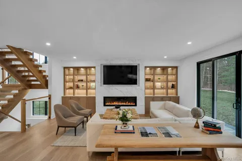 a living room with furniture and a fireplace