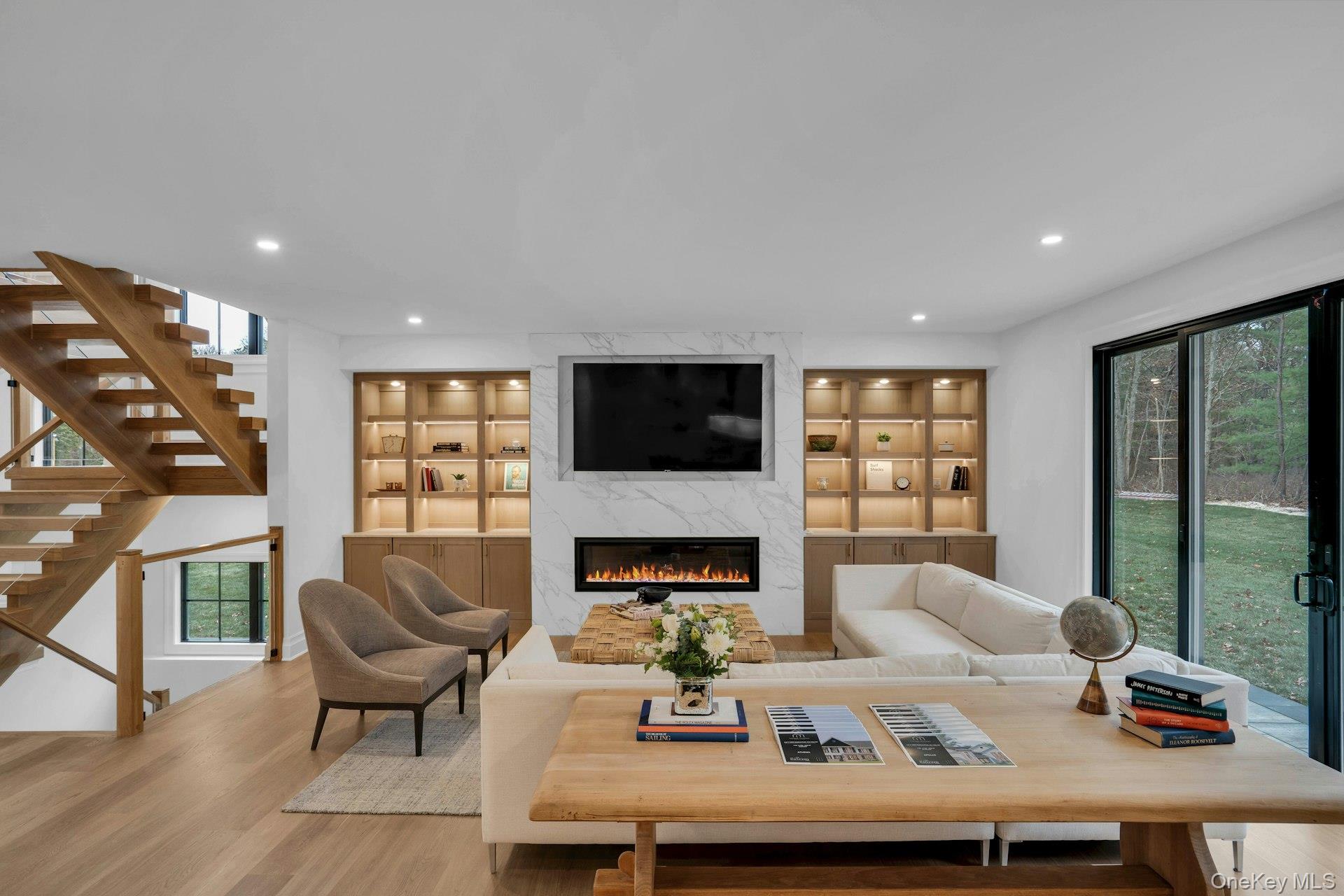 Lot 1-1003 Baldwin Path Dix Hills, NY 11746 - Photo 17 of 50 a living room with furniture fireplace and a flat screen tv