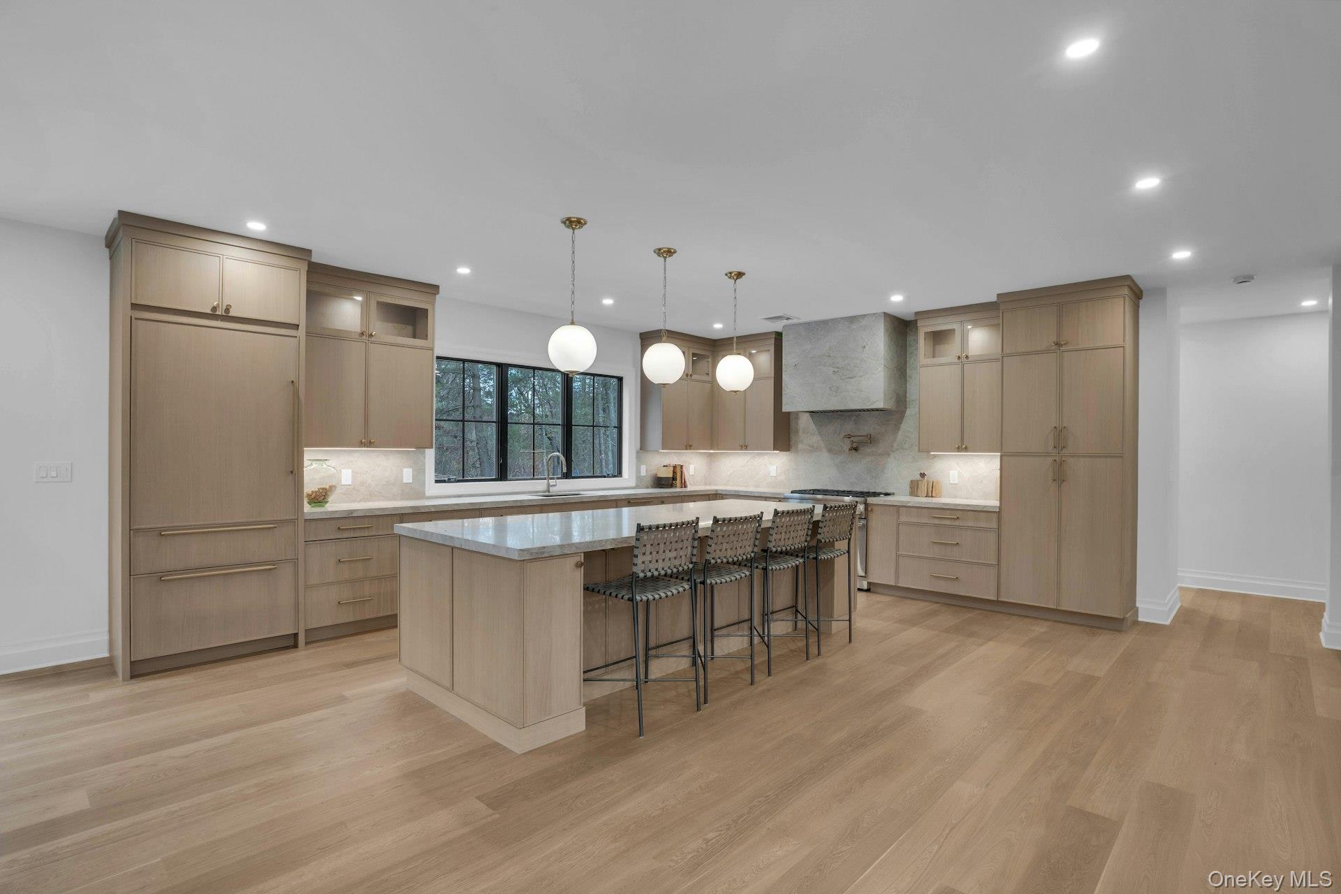 Lot 1-1003 Baldwin Path Dix Hills, NY 11746 - Photo 20 of 50 a kitchen with kitchen island granite countertop a sink and refrigerator