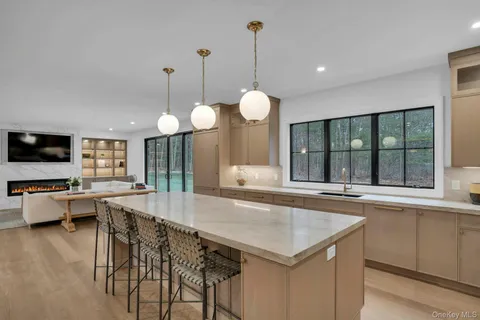 a kitchen with sink and large window