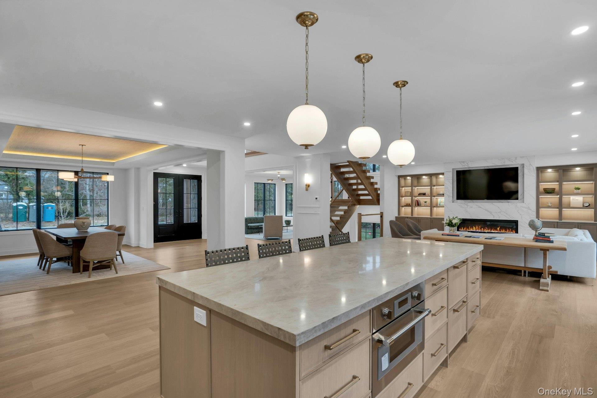 Lot 1-1003 Baldwin Path Dix Hills, NY 11746 - Photo 48 of 50 a kitchen with stainless steel appliances granite countertop a stove and a view of living room
