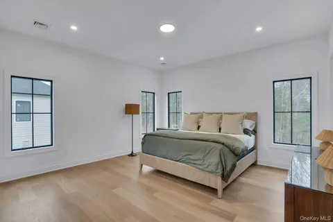 a spacious bedroom with a bed and window