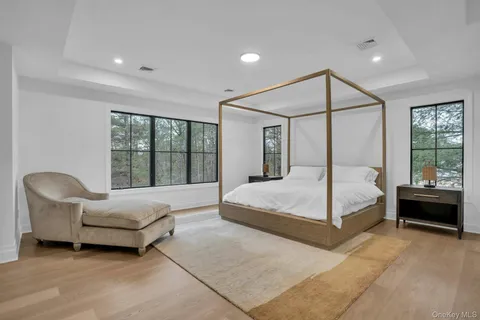 a bedroom with a bed couch and window