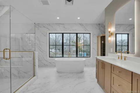 a spacious bathroom with a tub shower and sink