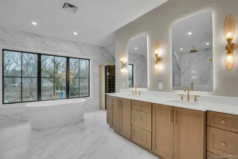 a large bathroom with a large tub and sink