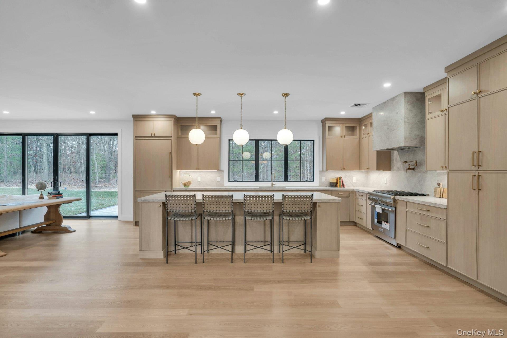 Lot 1-1003 Baldwin Path Dix Hills, NY 11746 - Photo 9 of 50 a large kitchen with a table and chairs