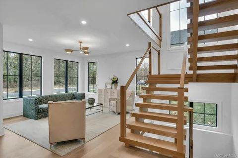 a living room with furniture and a chandelier