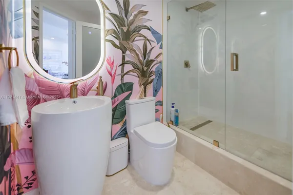 a bathroom with a sink toilet and shower