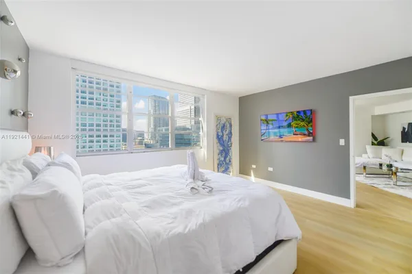 a bedroom with a large bed and a large window