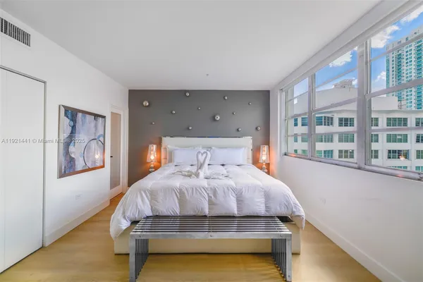 a bedroom with a bed and glass window