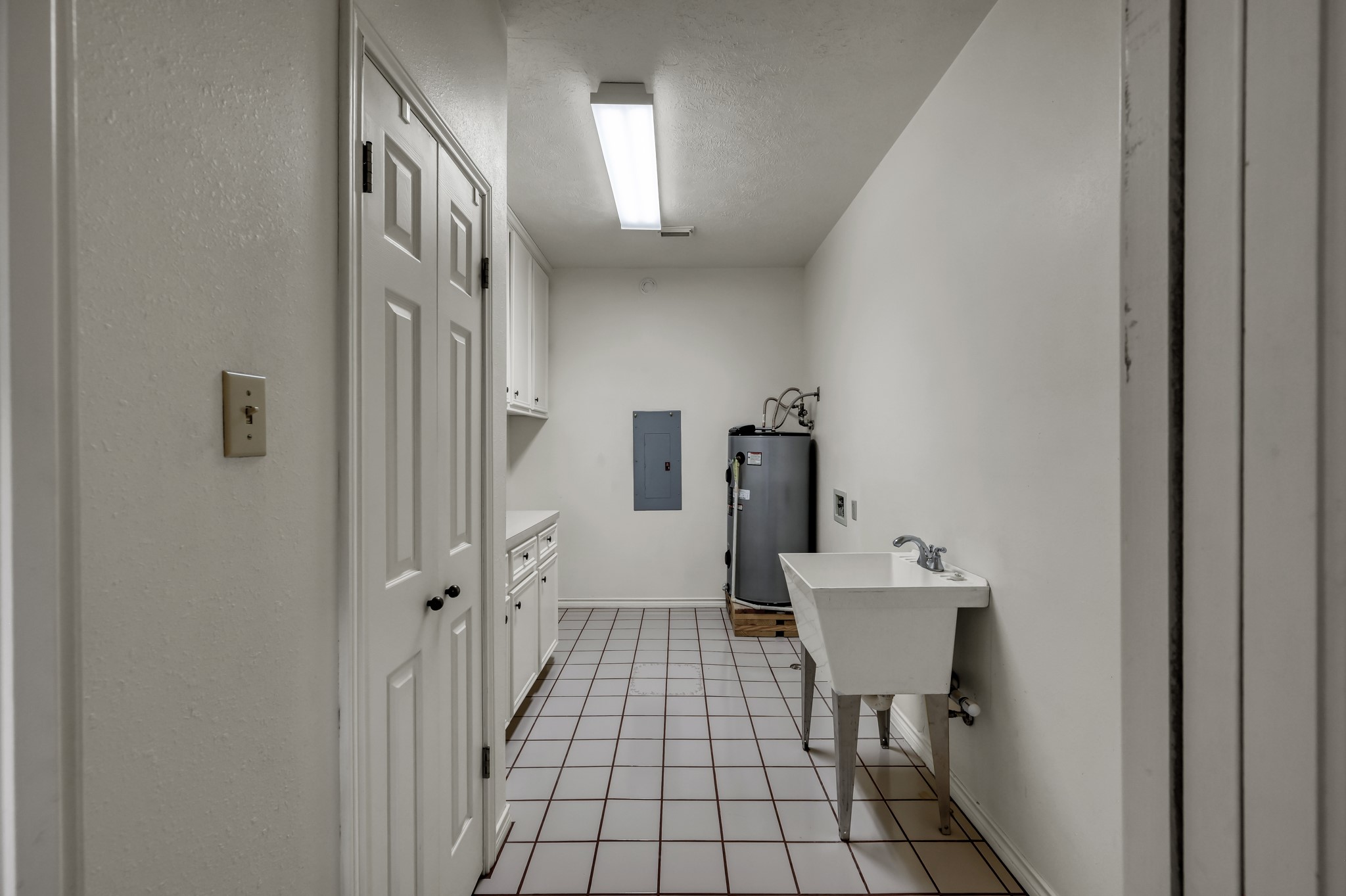 273 Augusta Drive Trinity, TX 75862 - Photo 29 of 50 Large utility room with tons of cabinets, broom closet, utility sink, and room for a stand up freezer.