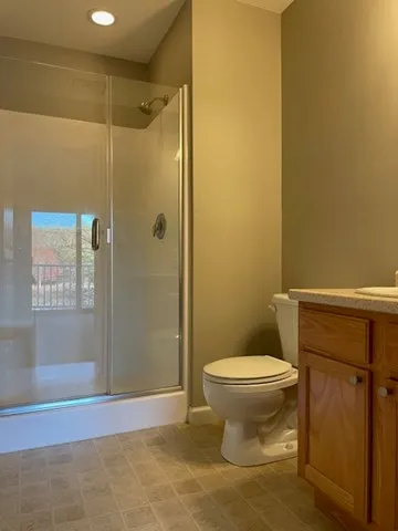 an empty room with closet and a window