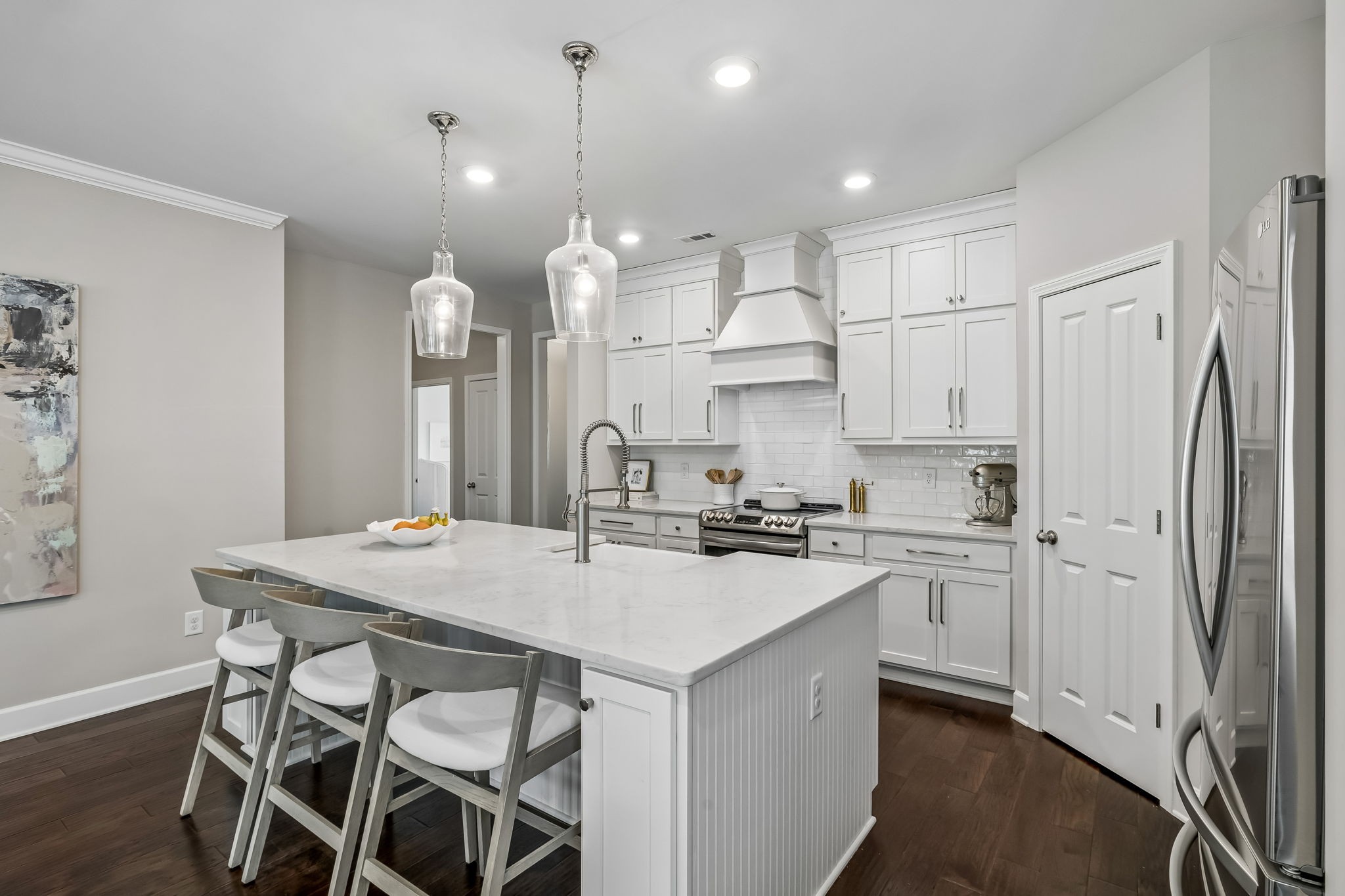 168 Mary Ann Circle Spring Hill, TN 37174 - Photo 11 of 38 a kitchen with stainless steel appliances granite countertop a stove a refrigerator a kitchen island a sink white cabinets and couches with wooden floor