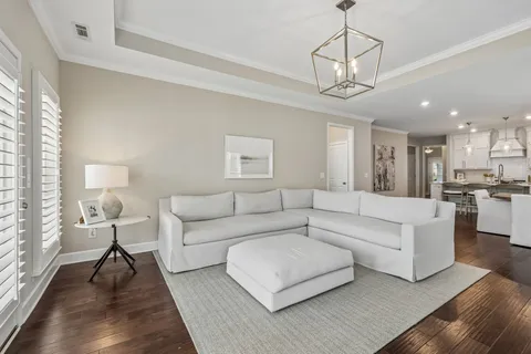 a living room with furniture a chandelier and a chandelier
