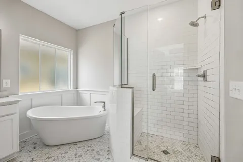 a bathroom with a bathtub and shower
