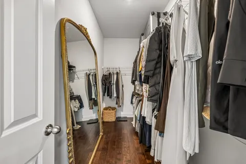 a view of walk in closet with clothes