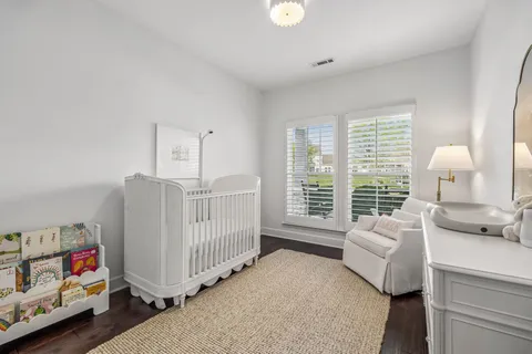 a bedroom with furniture and a large window