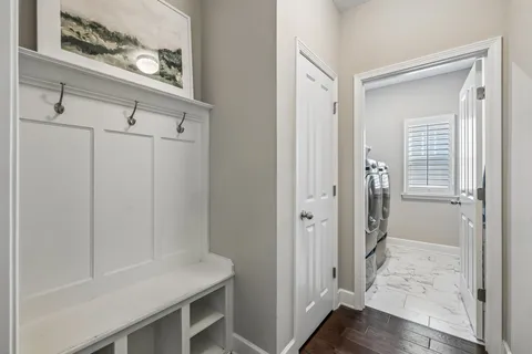 a view of a hallway with paintings on the wall