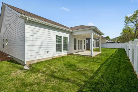 a view of a house with backyard and porch