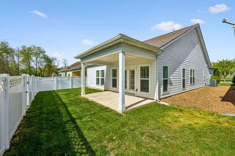 a view of a house with backyard and porch
