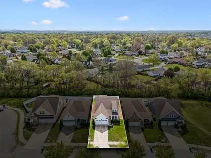 an aerial view of a house with a swimming pool outdoor seating and yard
