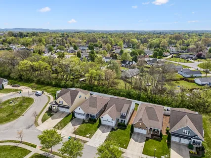 an aerial view of residential houses with outdoor space