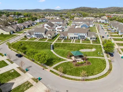 an aerial view of residential houses with outdoor space and pool