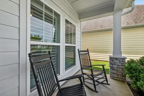 a view of a balcony with chairs