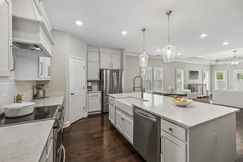 a kitchen with stainless steel appliances a sink stove and refrigerator