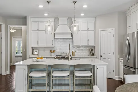 a kitchen with a sink cabinets and refrigerator