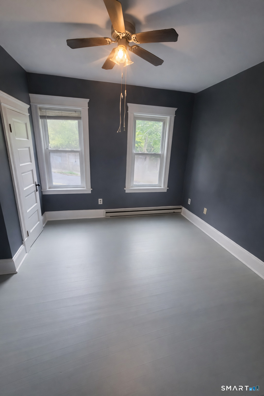 155 Congress Avenue, Unit 2 Waterbury, CT 06708 - Photo 3 of 7 an empty room with windows and fan