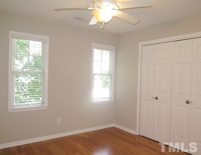 2544 Noble Road Raleigh, NC 27608 - Photo 8 of 11 a view of an empty room with wooden floor and a window