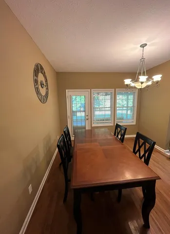 a view of a dining room with furniture and window