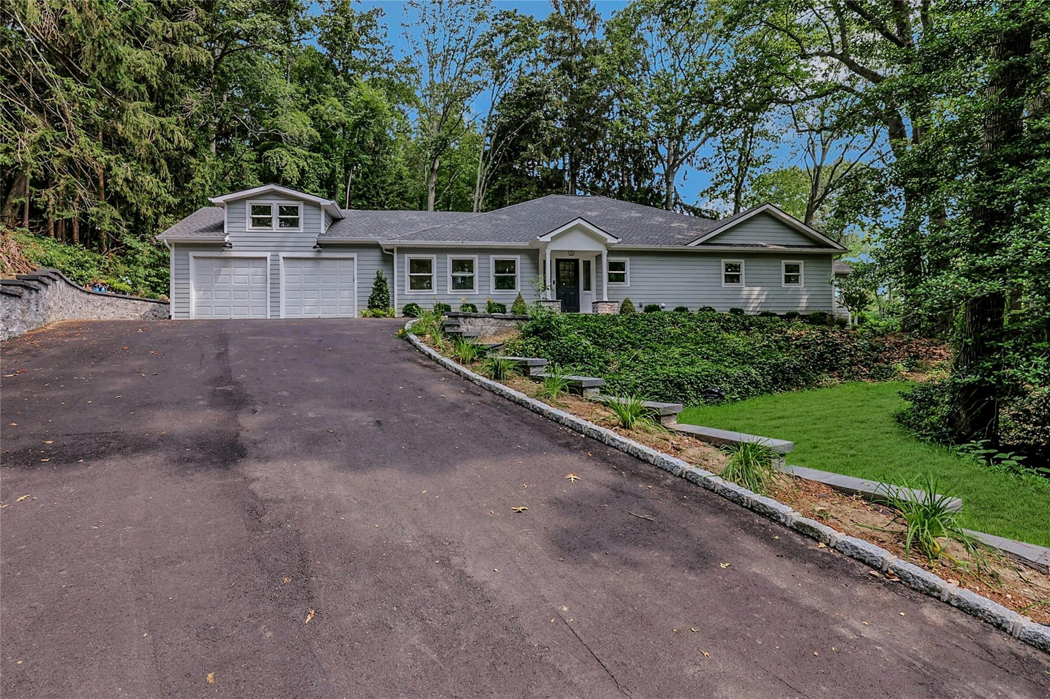 a front view of a house with a yard and garage