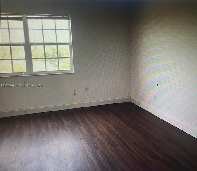 900 Southwest 84th Avenue, Unit 415D Miami, FL 33144 - Photo 11 of 19 an empty room with wooden floor and windows
